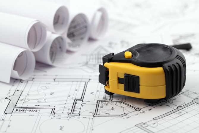 rolls of architectural house plans & tape measure