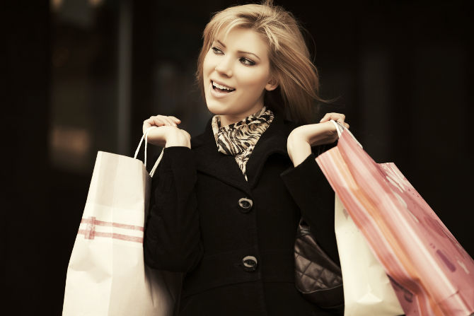 Happy young fashion woman with shopping bags