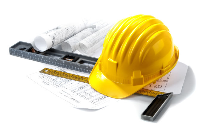 isolated hard hat with tools and blueprint on white