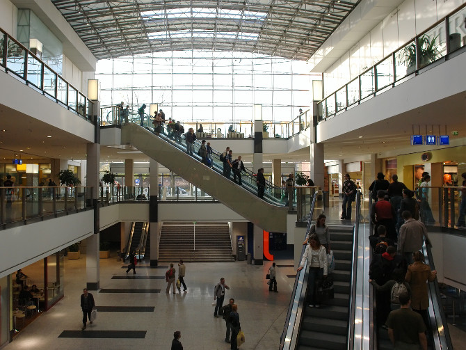 shoppers in a big shopping center with elevators