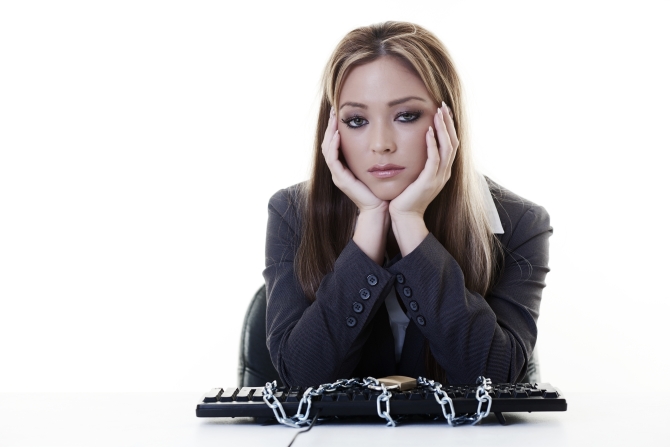 woman at her desk with her keyboard lock up in chains