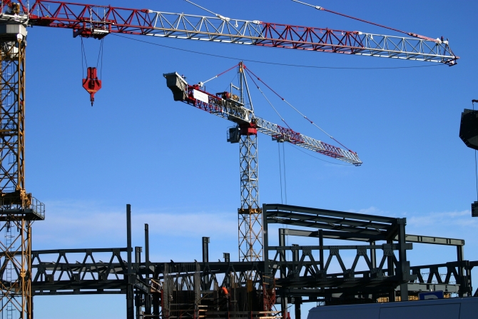 construction site including steel structure and crane