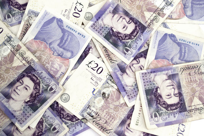 Twenty pounds sterling notes on a white background