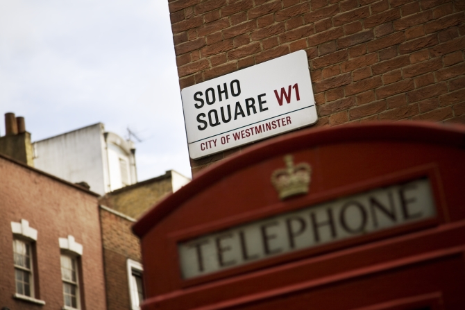 detail of soho square in london and a typical phone booth
