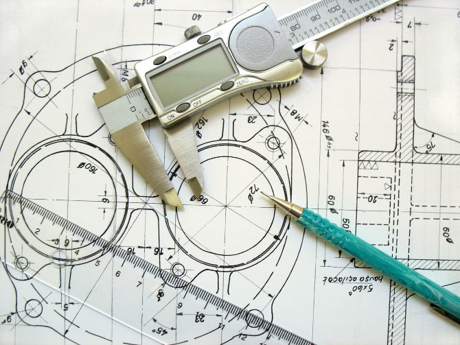 engineer tools on a technical drawing. caliper ruler and mechanical pencil.